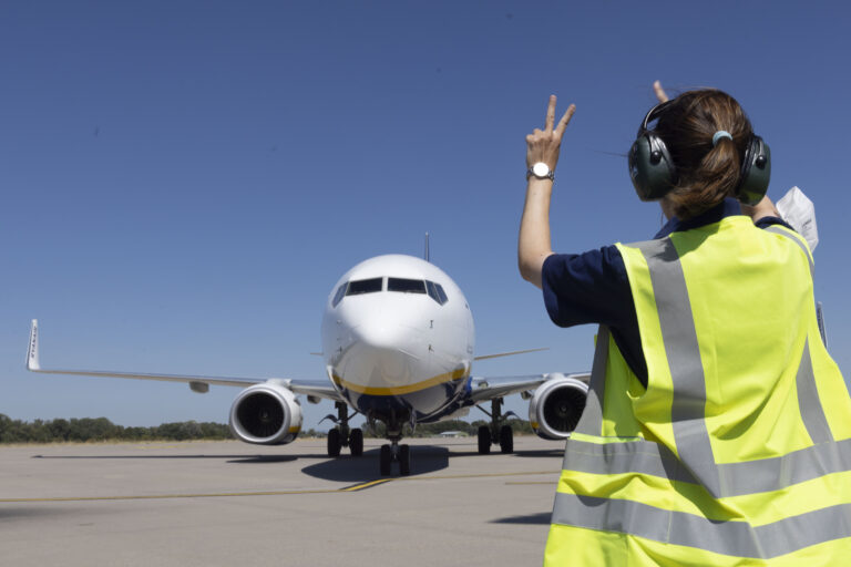 Mitarbeiterin vor einem Flugzeug